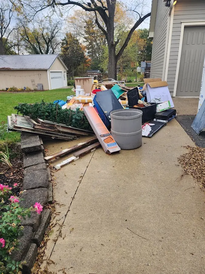 Dumpster being loaded with debris for 12 Yard Dumpster Rental in Columbus